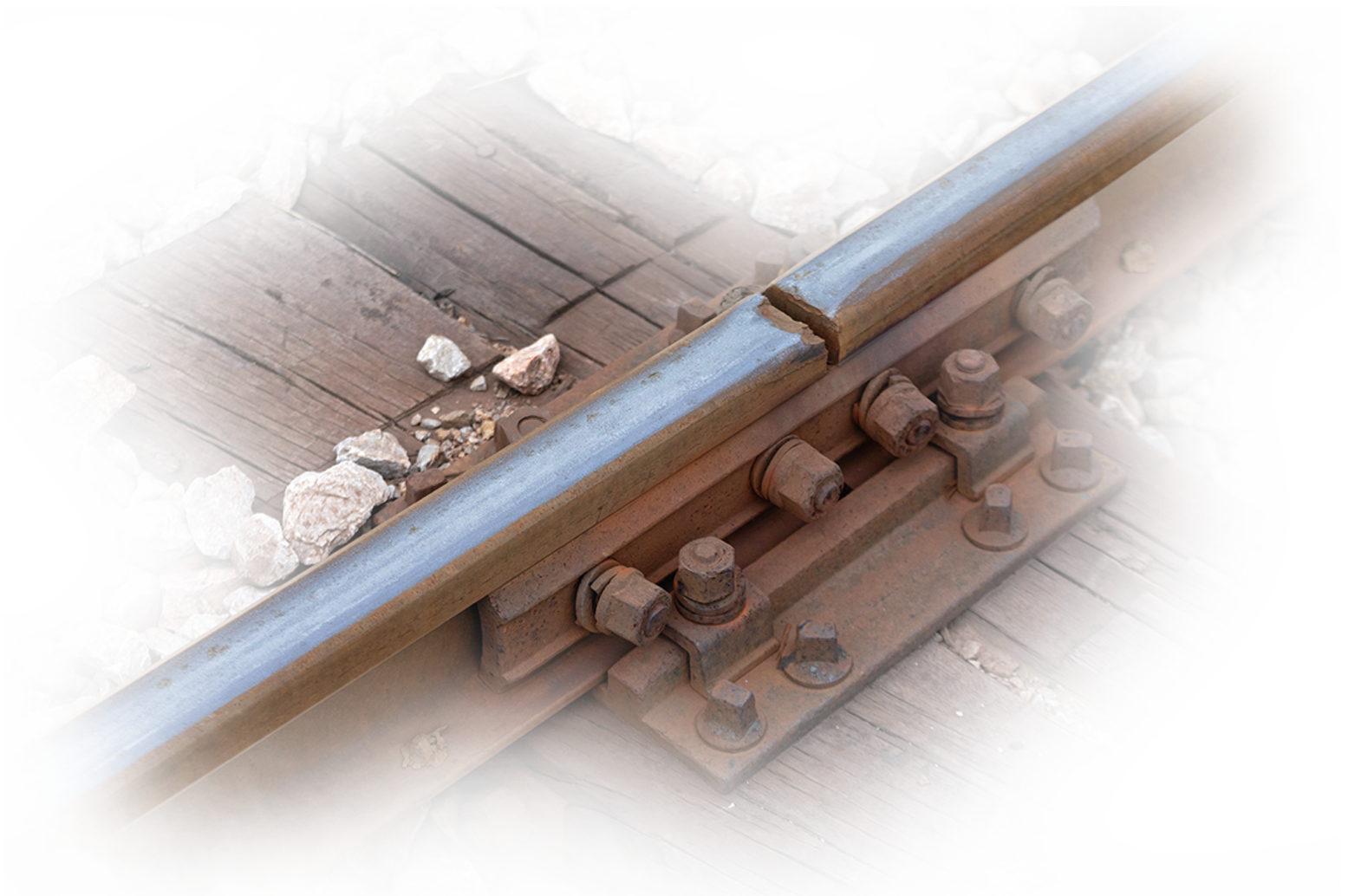 Close-up of a damaged railway track with visible cracks and wear, highlighting the need for advanced material wear monitoring and predictive maintenance in rail infrastructure.